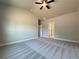 A spacious bedroom with neutral walls, soft carpet, and a contemporary ceiling fan at 5706 Urban Village Way # 4, Tucker, GA 30084