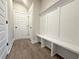 Entryway boasts coat hooks, bench seating, storage cabinets, and durable flooring at 5706 Urban Village Way # 4, Tucker, GA 30084