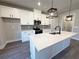 Modern kitchen featuring white cabinets, quartz countertops, stainless steel appliances, and a center island with sink at 5706 Urban Village Way # 4, Tucker, GA 30084