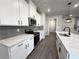 Kitchen offers stainless steel appliances, white shaker cabinets, subway tile backsplash, and a center island at 5706 Urban Village Way # 4, Tucker, GA 30084