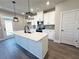 New kitchen features white cabinetry, quartz counters, stainless appliances, and a center island at 5706 Urban Village Way # 4, Tucker, GA 30084