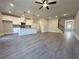 Open-concept living space showcasing wood floors, recessed lighting, kitchen island and lots of room for entertaining at 5706 Urban Village Way # 4, Tucker, GA 30084
