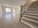 Open-concept living space, with view of stairs, a modern kitchen featuring a center island, and wood flooring at 5706 Urban Village Way # 4, Tucker, GA 30084