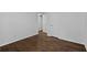 Large bedroom with hardwood floors, freshly painted walls, and doorway to another room at 1142 Palafox Ne Dr, Atlanta, GA 30324
