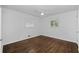 Cozy bedroom featuring hardwood floors, white walls and ample natural light from dual windows at 1142 Palafox Ne Dr, Atlanta, GA 30324