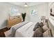 Bright bedroom featuring two windows, a ceiling fan, and a large dresser at 1142 Palafox Ne Dr, Atlanta, GA 30324