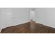 Spacious bedroom with hardwood floors and multiple doors, offering versatility at 1142 Palafox Ne Dr, Atlanta, GA 30324