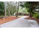 Wide driveway leading to a cozy home surrounded by mature trees and well-kept landscaping at 1142 Palafox Ne Dr, Atlanta, GA 30324