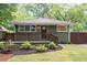 Charming front exterior with an inviting front porch and beautiful landscaping at 1142 Palafox Ne Dr, Atlanta, GA 30324