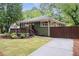 Charming home with a manicured lawn, inviting porch, and lush landscaping at 1142 Palafox Ne Dr, Atlanta, GA 30324
