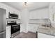 Well-lit kitchen featuring stainless steel appliances, granite countertops, and white cabinetry at 1142 Palafox Ne Dr, Atlanta, GA 30324