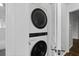 Stackable laundry in a closet with white cabinets at 1142 Palafox Ne Dr, Atlanta, GA 30324