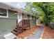 Side exterior with stairs leading to the back and a gravel path leading to the studio at 1142 Palafox Ne Dr, Atlanta, GA 30324
