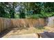 Small backyard has a wooden fence, minimal grass, and a concrete patio at 2249 Knoxhill Se Vw, Smyrna, GA 30082