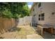 Small backyard has a wooden fence, minimal grass, and the home's exterior is visible at 2249 Knoxhill Se Vw, Smyrna, GA 30082