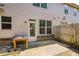 Small backyard has a wooden fence, concrete patio, and back door with large windows at 2249 Knoxhill Se Vw, Smyrna, GA 30082