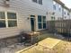 View of the home's backyard with a patio and wood fence at 2249 Knoxhill Se Vw, Smyrna, GA 30082