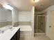 Bathroom showcasing a vanity with a bathtub and separate shower stall at 2249 Knoxhill Se Vw, Smyrna, GA 30082