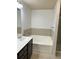 Bright bathroom with a tub and dark vanity at 2249 Knoxhill Se Vw, Smyrna, GA 30082