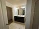 A shared bathroom with double sinks and a tile floor at 2249 Knoxhill Se Vw, Smyrna, GA 30082