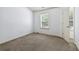 Bedroom features neutral walls and carpet, plus a window providing natural light at 2249 Knoxhill Se Vw, Smyrna, GA 30082
