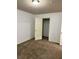 Bedroom featuring neutral walls and carpets with an open door to the walk in closet at 2249 Knoxhill Se Vw, Smyrna, GA 30082