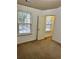A bedroom with neutral colored walls and carpet and a window letting in natural light at 2249 Knoxhill Se Vw, Smyrna, GA 30082