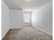 This bedroom features neutral carpet, light walls, and a window providing natural light at 2249 Knoxhill Se Vw, Smyrna, GA 30082