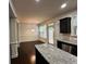 Open-concept dining area with hardwood floors and view into modern kitchen at 2249 Knoxhill Se Vw, Smyrna, GA 30082