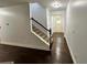 Bright entryway with hardwood floors, visible stairs, and leading to the front door at 2249 Knoxhill Se Vw, Smyrna, GA 30082