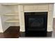 Living room fireplace with white mantel, black firebox, and shelving at 2249 Knoxhill Se Vw, Smyrna, GA 30082