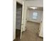 Hallway with a view of a walk-in closet with wire shelves and a carpeted bedroom at 2249 Knoxhill Se Vw, Smyrna, GA 30082