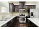 Kitchen features stainless steel appliances, granite counters, dark wood cabinets and hardwood floors at 2249 Knoxhill Se Vw, Smyrna, GA 30082