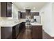 Updated kitchen showcases dark wood cabinets, granite counters, stainless steel appliances and an island at 2249 Knoxhill Se Vw, Smyrna, GA 30082