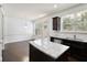 Well-lit kitchen featuring stainless steel appliances, dark wood cabinets, granite countertops, and hardwood flooring at 2249 Knoxhill Se Vw, Smyrna, GA 30082