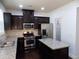 Modern kitchen with dark cabinets, stainless steel appliances, and granite countertops at 2249 Knoxhill Se Vw, Smyrna, GA 30082