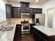 Kitchen with stainless appliances, granite countertops, dark cabinets and hardwood floors at 2249 Knoxhill Se Vw, Smyrna, GA 30082