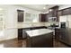 Beautiful kitchen with stainless steel appliances, granite counters, dark wood cabinets, an island and hardwood floors at 2249 Knoxhill Se Vw, Smyrna, GA 30082