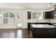 Modern kitchen boasting dark cabinets, granite countertops, stainless steel appliances, and hardwood flooring at 2249 Knoxhill Se Vw, Smyrna, GA 30082