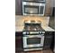 A stainless steel oven/stove and microwave are set into dark wood cabinetry at 2249 Knoxhill Se Vw, Smyrna, GA 30082