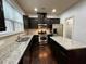 Modern kitchen with dark cabinets, stainless steel appliances, and granite countertops at 2249 Knoxhill Se Vw, Smyrna, GA 30082