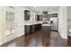 Modern kitchen boasts dark cabinets, granite counters, stainless steel appliances, an island and hardwood floors at 2249 Knoxhill Se Vw, Smyrna, GA 30082
