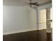 Bright living room with hardwood floors, a ceiling fan, and decorative columns at 2249 Knoxhill Se Vw, Smyrna, GA 30082