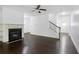 Spacious living room with hardwood floors and a cozy fireplace with mantle at 2249 Knoxhill Se Vw, Smyrna, GA 30082