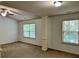 Bright living area with columns, ceiling fan, and natural light through windows at 2249 Knoxhill Se Vw, Smyrna, GA 30082