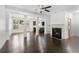 Open-concept living room featuring hardwood floors, a fireplace, and natural light at 2249 Knoxhill Se Vw, Smyrna, GA 30082