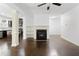 Open living room with hardwood floors, columns, and built-in shelves next to the fireplace at 2249 Knoxhill Se Vw, Smyrna, GA 30082