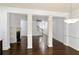 Open-concept living room with hardwood floors, fireplace and decorative columns at 2249 Knoxhill Se Vw, Smyrna, GA 30082