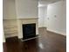 Living room featuring a fireplace with white mantle and shelving with hardwood floors at 2249 Knoxhill Se Vw, Smyrna, GA 30082