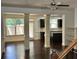 Open living space featuring hardwood floors, decorative columns, and kitchen access at 2249 Knoxhill Se Vw, Smyrna, GA 30082